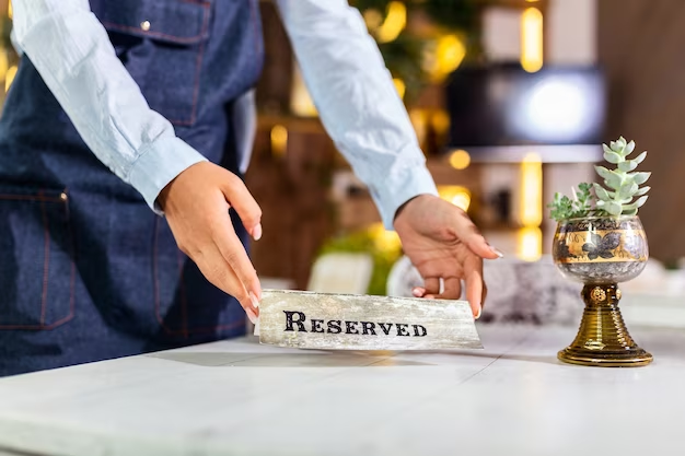 Restaurant table with a 'Reserved' card being placed on it