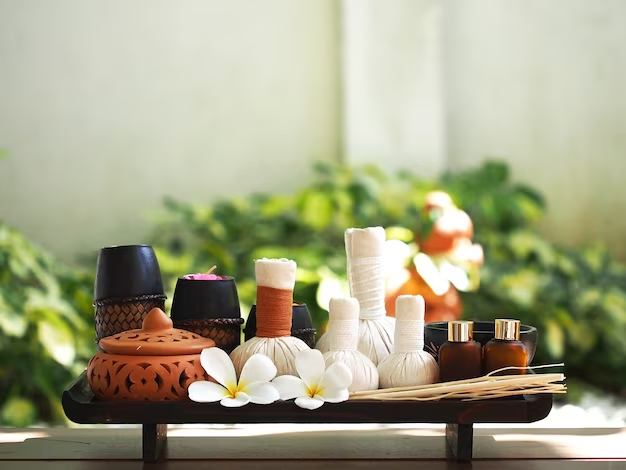 Image of Thai Spa Massage Compress Ball with Essential Oils, Pots, and Flowers All Together