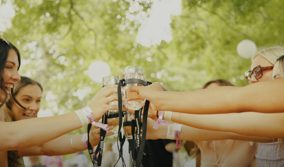 People at a table raising wine glasses in a toast